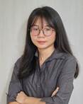 A person with long hair wearing glasses  AI-generated content may be incorrect.